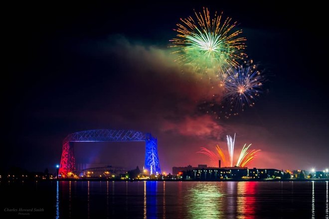 Duluth fireworks above Lake Superior with the Duluth Aerial Liftbridge colored red and blue