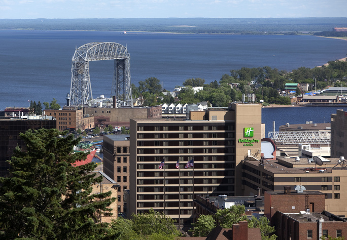 An overlook of Downtown Duluth, MN with the Aerial Lift Bridge and Lake Superior in the background on a bright summer day