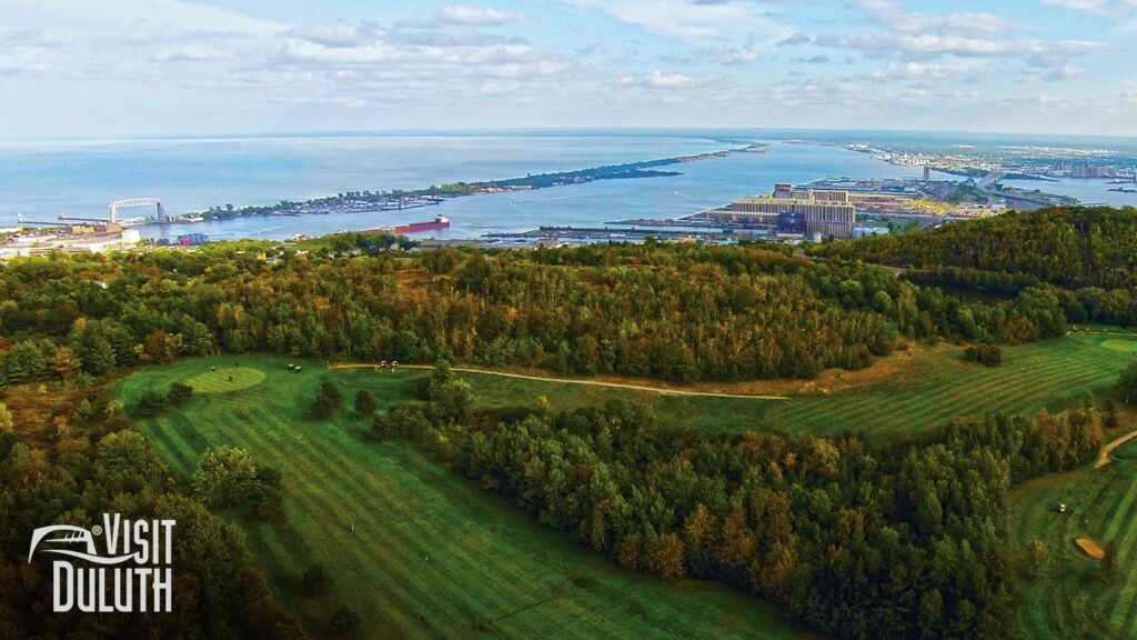 An aerial view of Enger Park Golf Course with the lake and harbor in the distance.