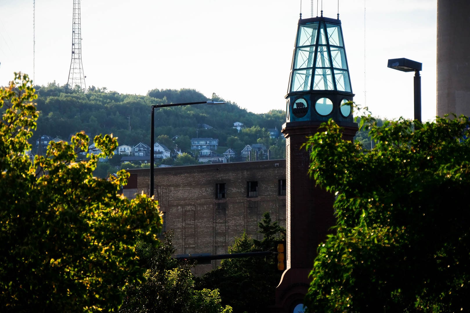 Canal Park Clock Tower closeup with the Central Hillside in the distance.