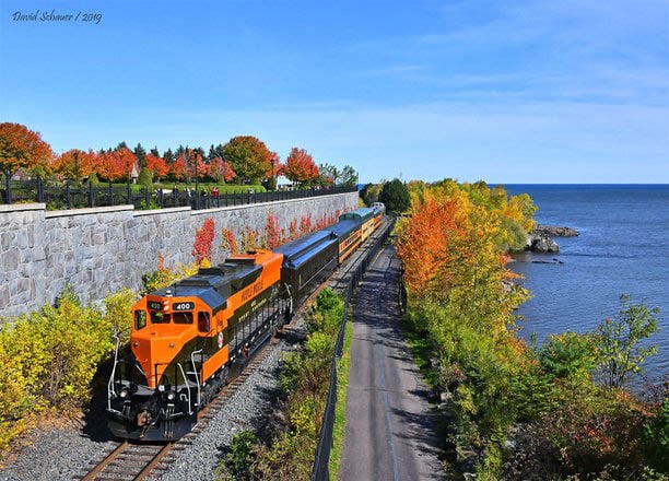 The North Shore Scenic Railroad riding toward canal park alongside the Lake Walk during a beautiful fall day.