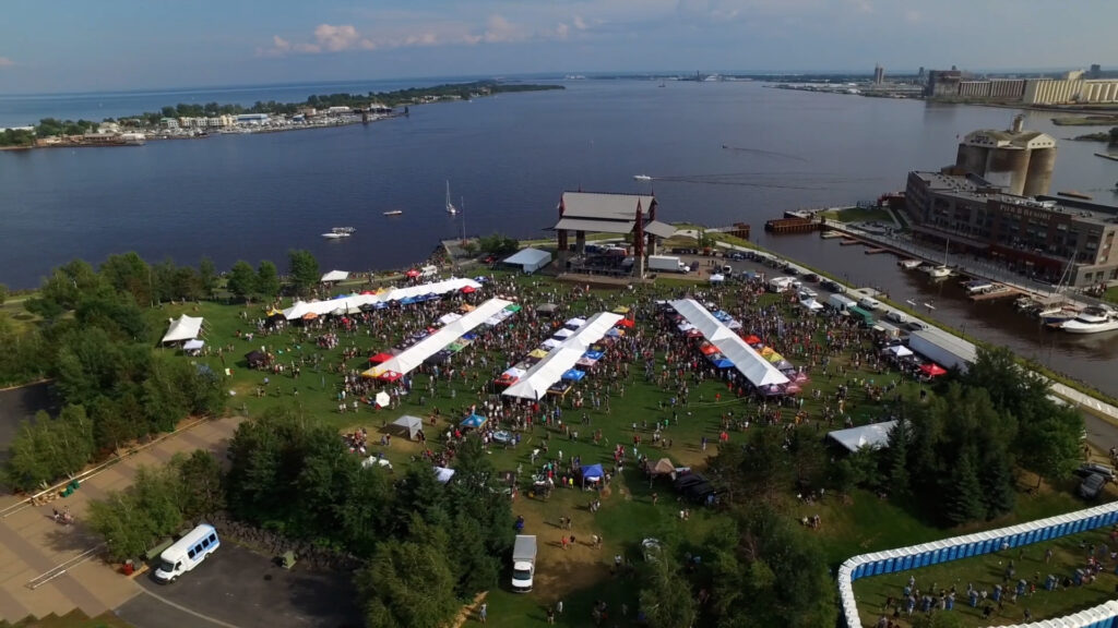 A view from the sky of multiple vendors, tents and crowd at Bayfront Park.