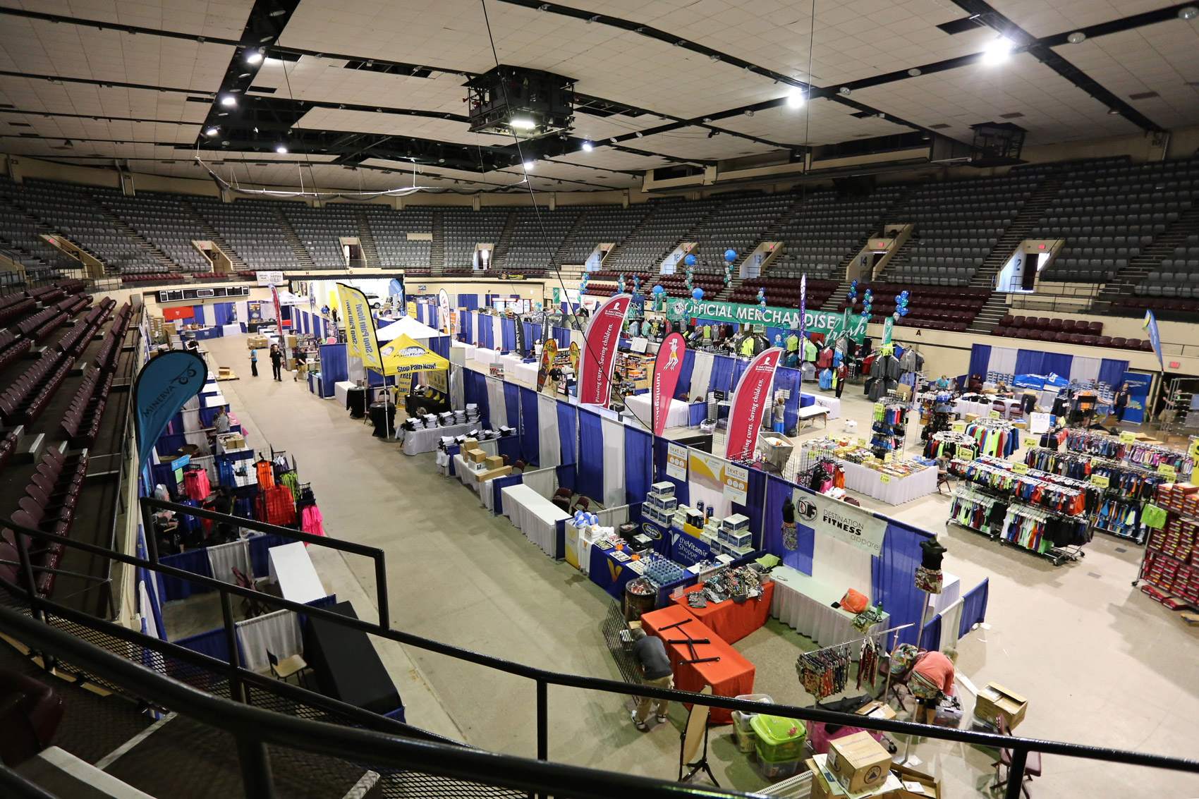 Several rows of vendor booths at the DECC arena from a ceiling perspective
