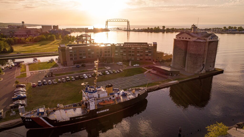 A shot looking down on the PierB Grain elevators with the bridge in the background with a sunrise.