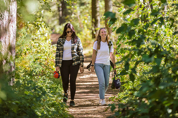two girls walking on a trail