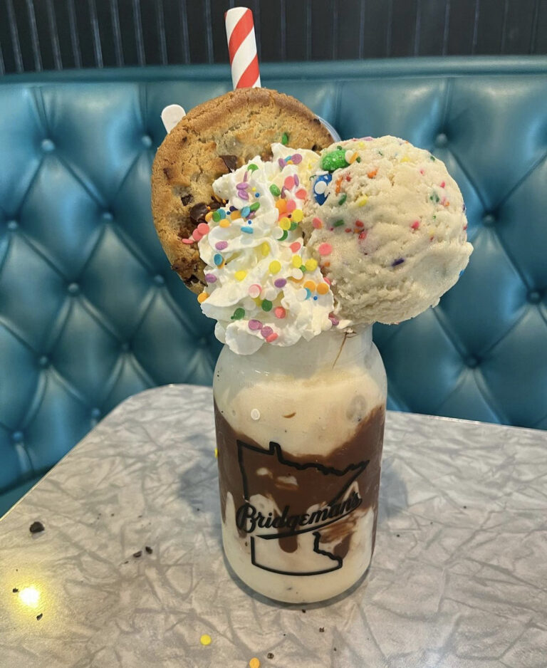 milkshake with whipped cream, cookies, and sprinkles