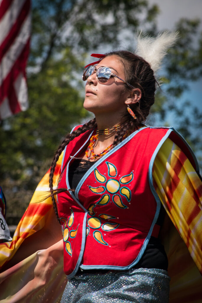 Geezisokwe Ojibwe – Fancy Shawl Dancer. Photo of Geezisokwe dancing at the Fond du Lac Ojibwe Reservation’s Veterans Powwow in 2019.  Photo by Ivy Vainio
