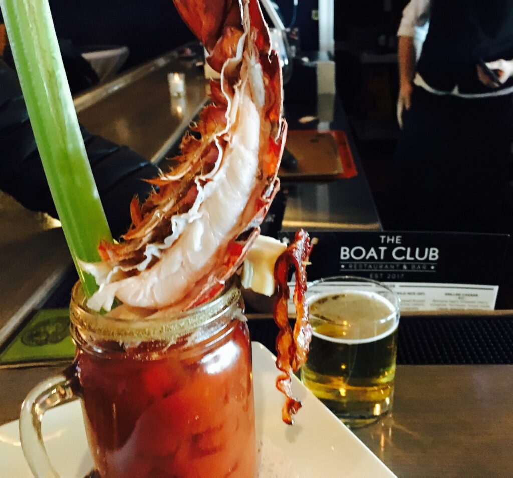 Image of a bloody mary with a lobster tail from The Boat Club restaurant