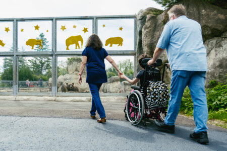 A family and child in a wheelchair enjoy the Lake Superior Zoo