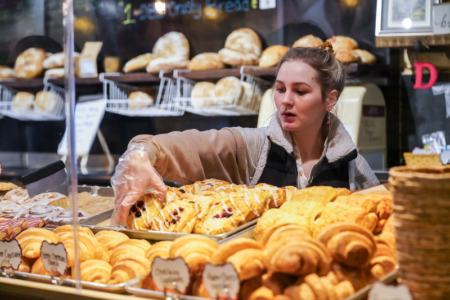 An employee grabbing a pastry at Duluth's Best Bread