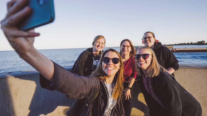 a group of girlfriends smile for a picture