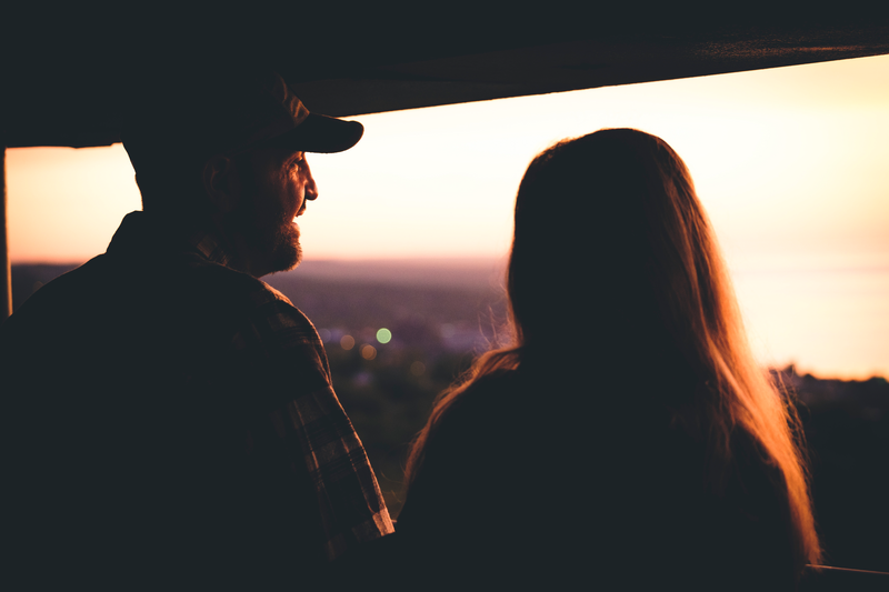 A couple stands at Enger Tower at sunset