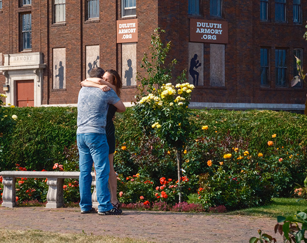 Couple hugging in a garden