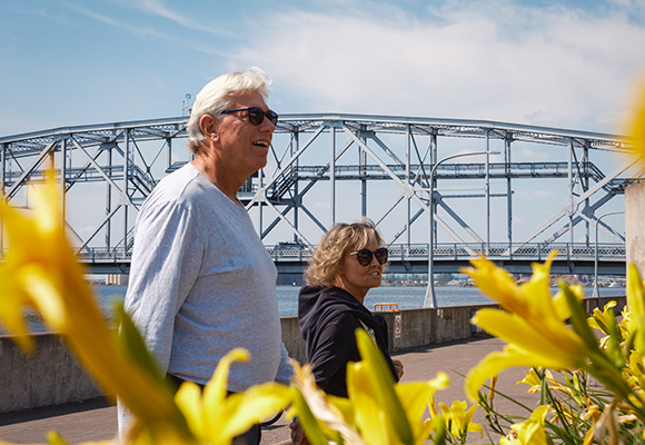a couple walking by the arial lift bridge