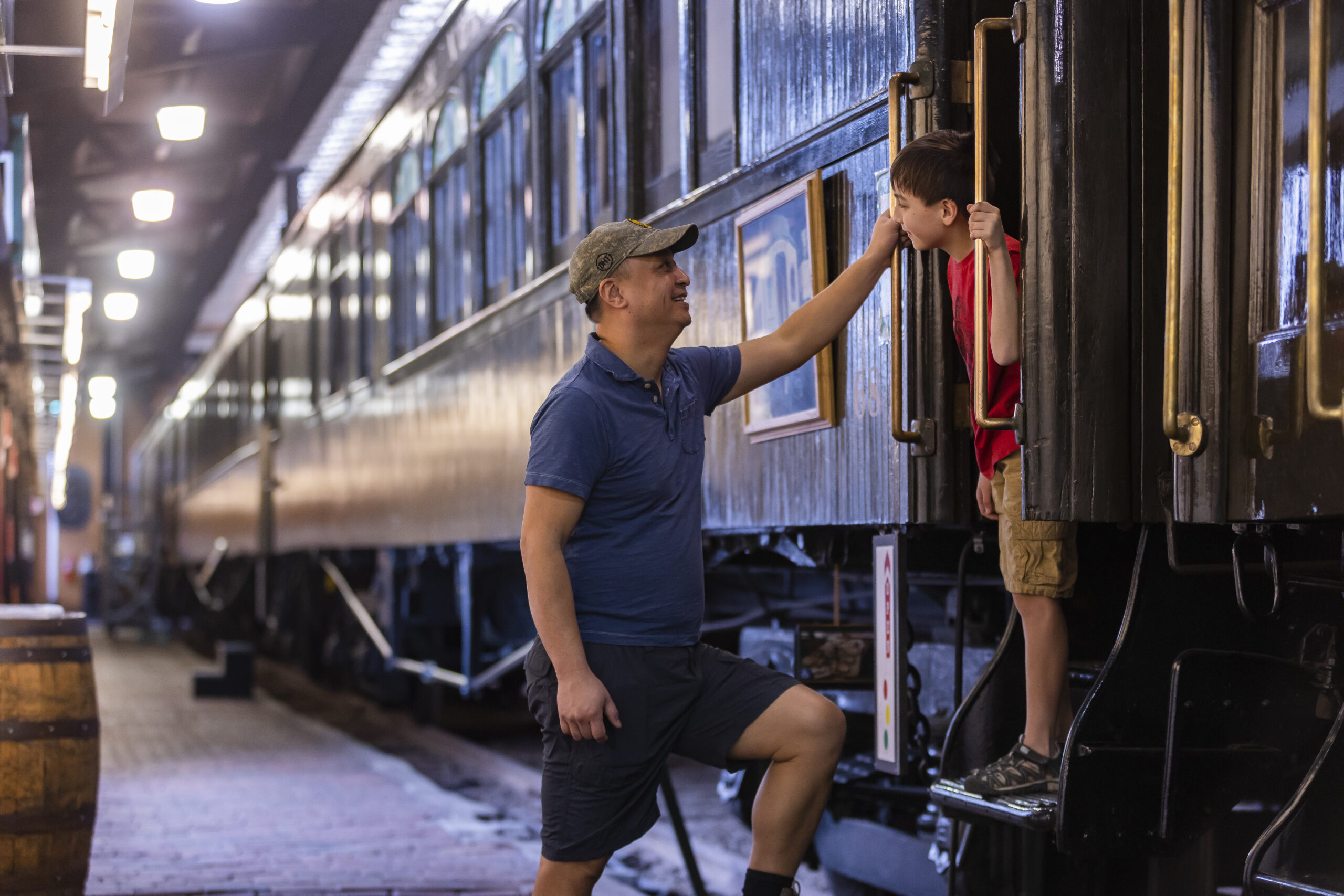 father and son looking at a train