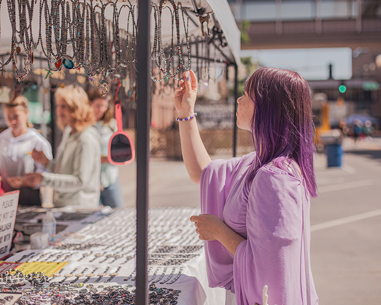 person looking at necklaces