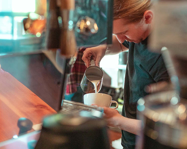 pouring milk in coffee