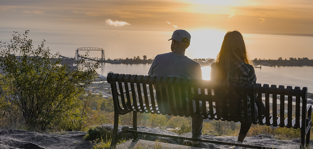 Two people sitting on a bench in Duluth