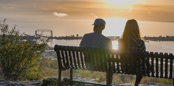 Two people sitting on a bench in Duluth