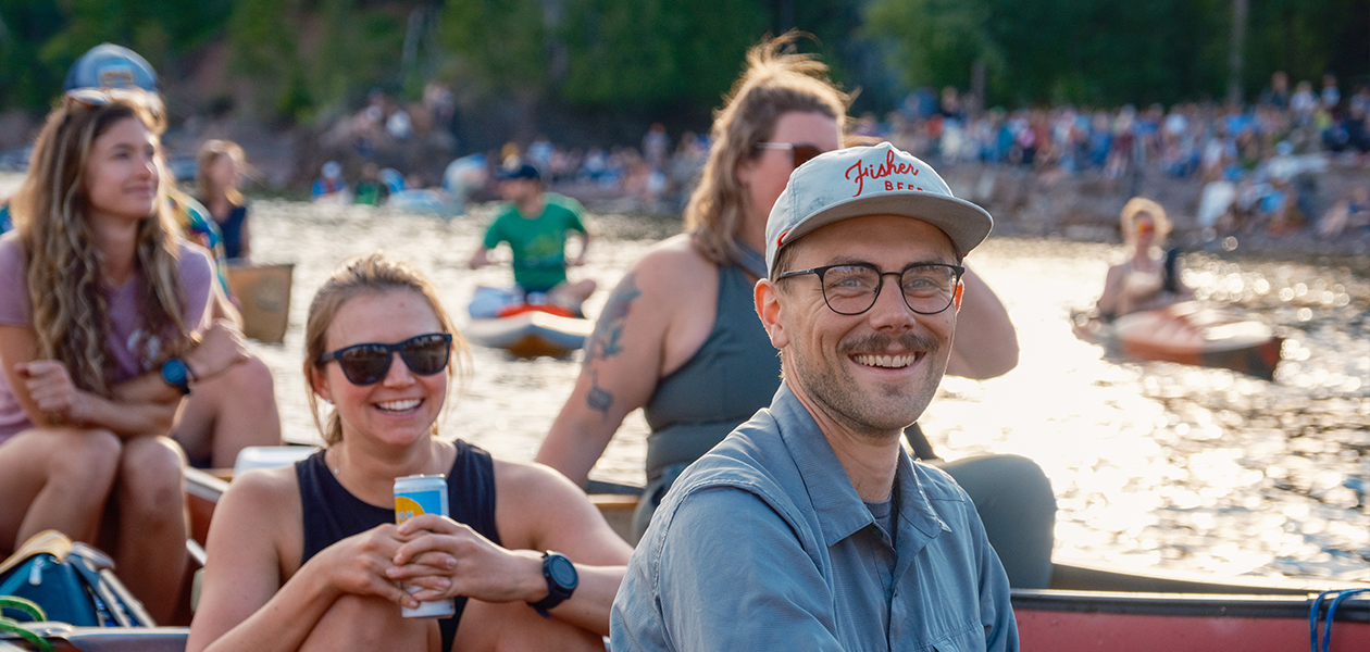 People smiling at an outdoor concert