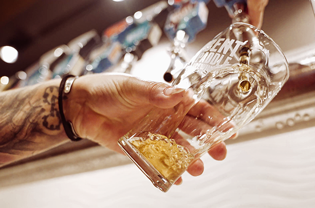 Person pouring a beer