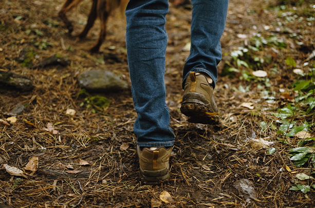 Boots walking through brown leaves