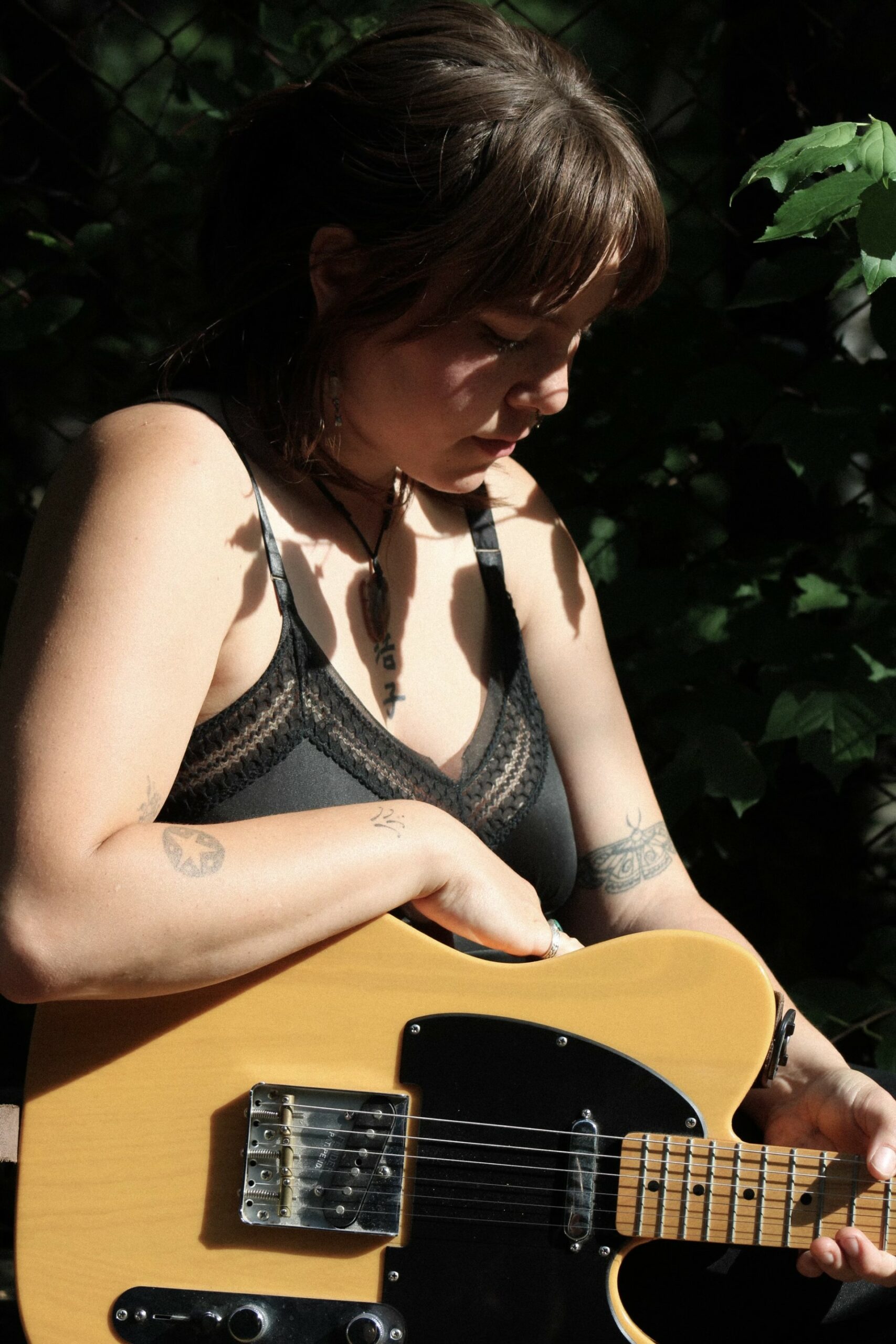 woman looking at guitar