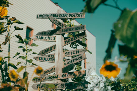 Wooden signpost with directional arrows in the lincoln park craft district in duluth, mn.
