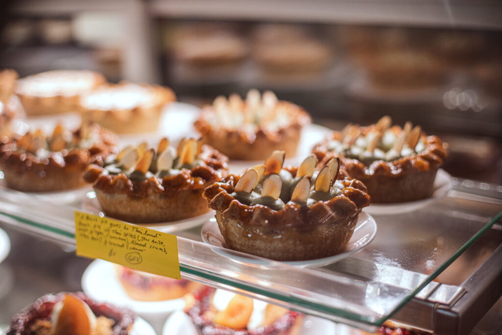 close up image of fancy small pies in a bakery case