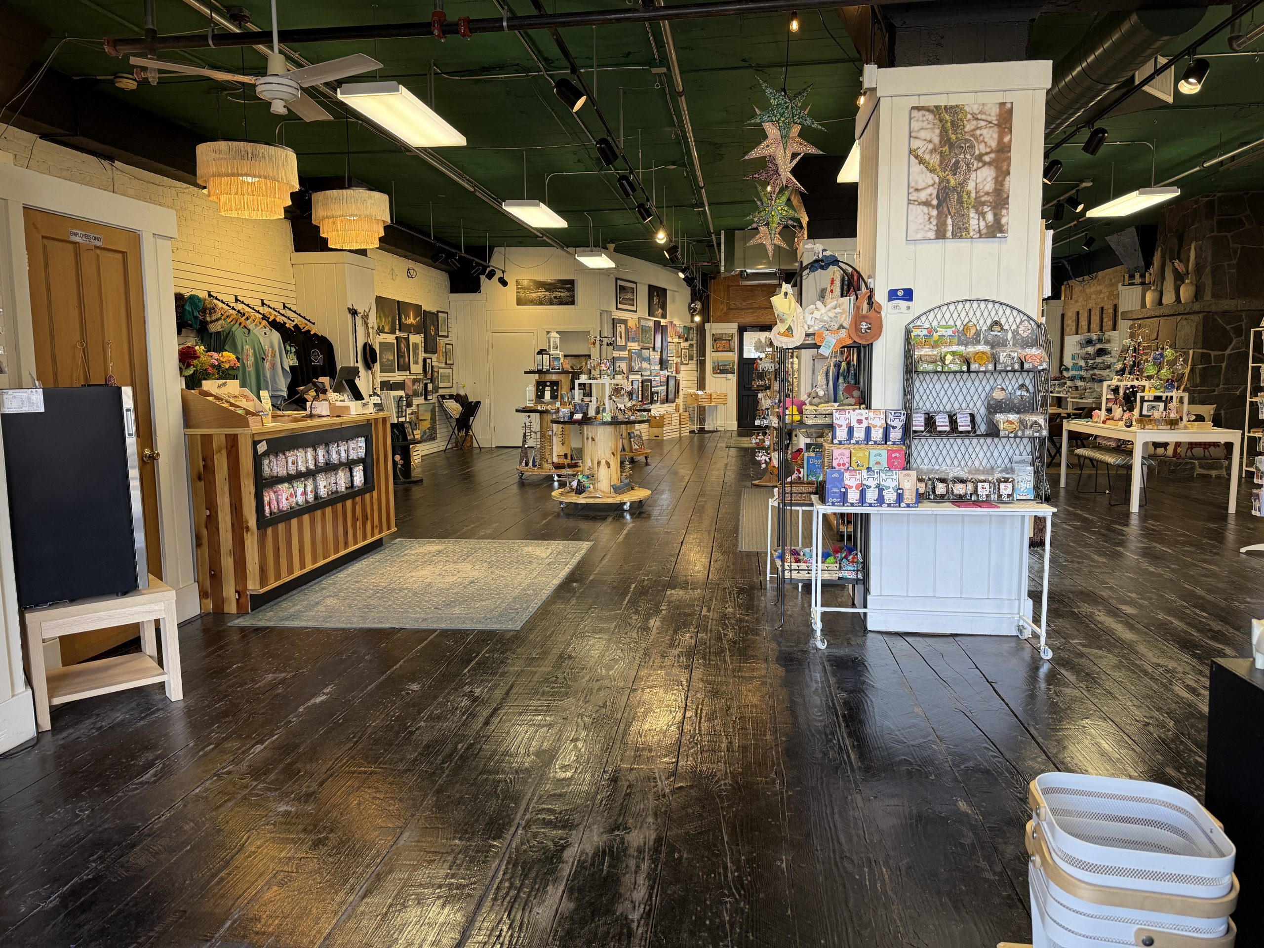 Interior of the duluth studio market boutique gift shop, featuring artisan displays, local art, and handmade gifts on dark wood floors