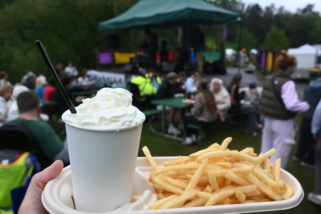 Chester bowl fall fest returns to duluth 6 Hot coffee topped with whipped cream and french fries held in front of picnic tables and the music stage at chester bowl fall fest.