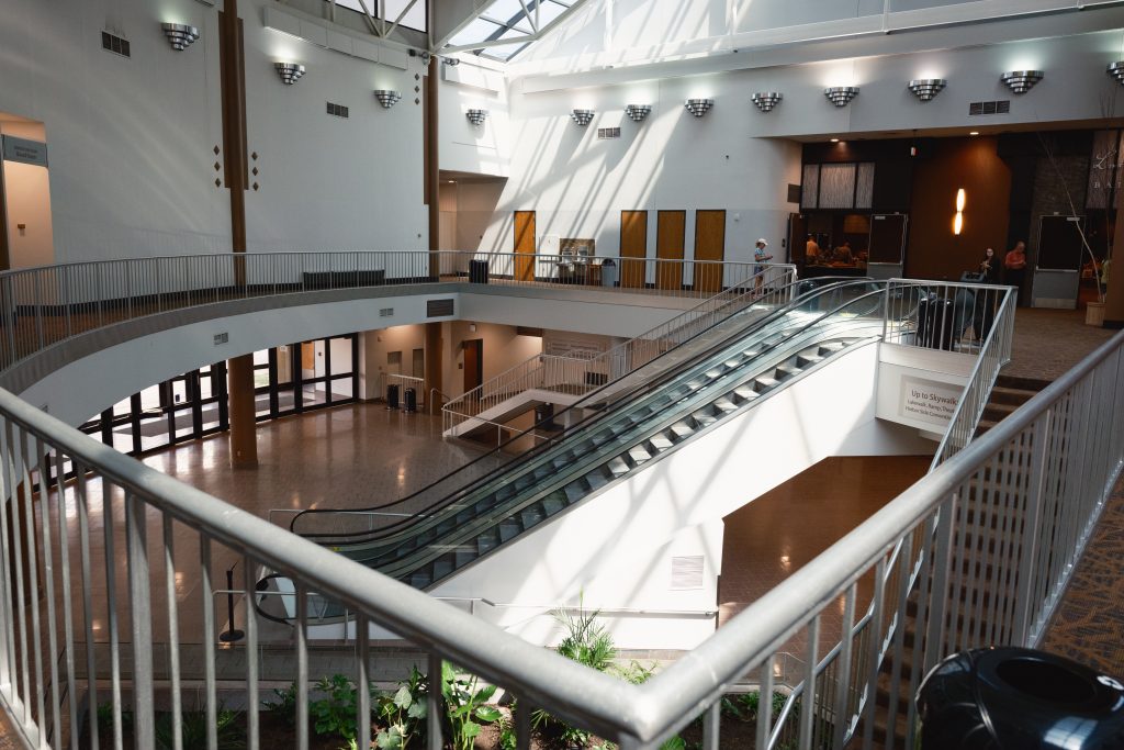 Modern duluth entertainment convention center (decc) interior with escalators and light that leads to the skywalk system in duluth, mn.