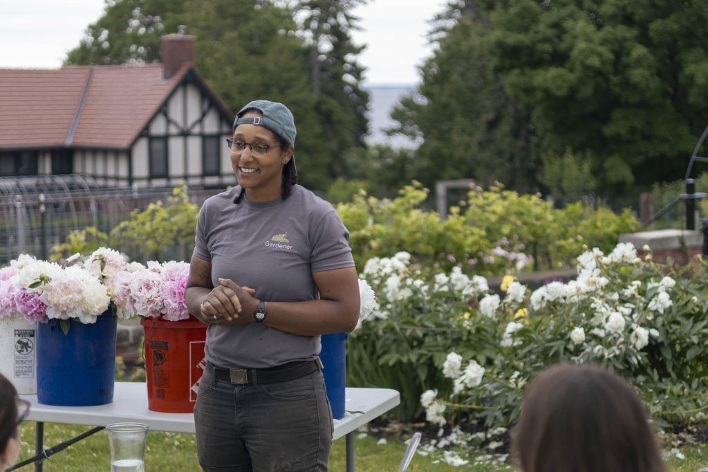 Insights from glensheen’s gardens with head gardener emily ford 14 Head gardener emily ford smiles while leading a workshop next to buckets of fresh-cut peonies at glensheen in duluth.