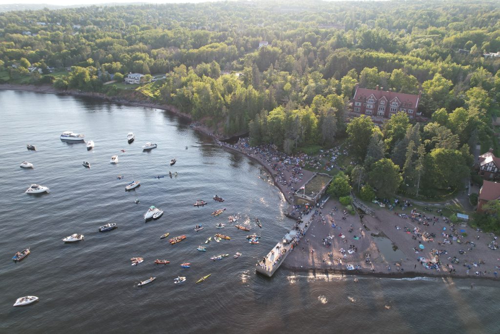 Insights from glensheen’s gardens with head gardener emily ford 1 Drone view of a concert crowd on glensheen’s shoreline, with boats and kayaks gathered on lake superior beside the pier.